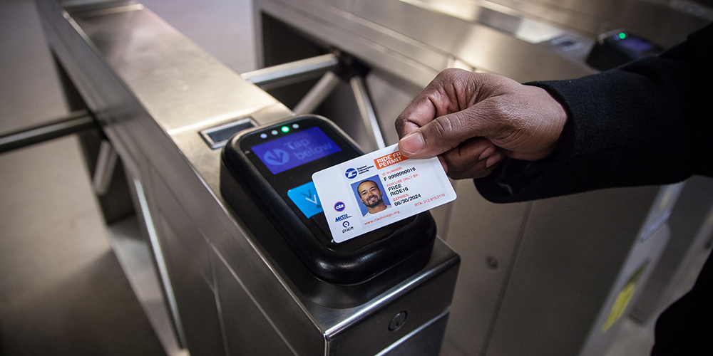 Person swiping ride free permit card on transit