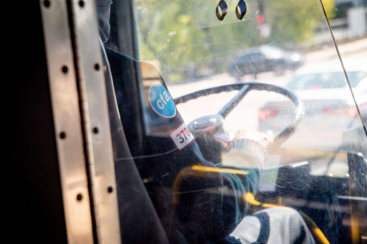 CTA bus driver using steering wheel.