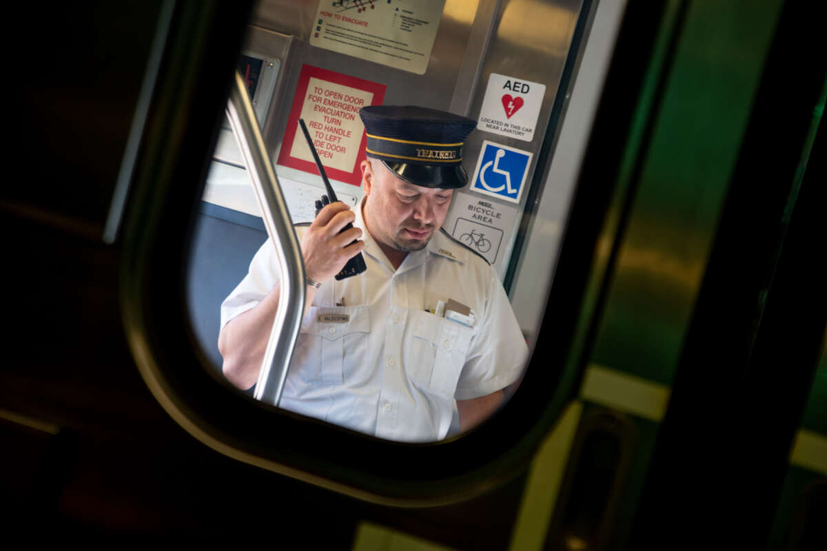 Metra conductor on walkie-talkie.