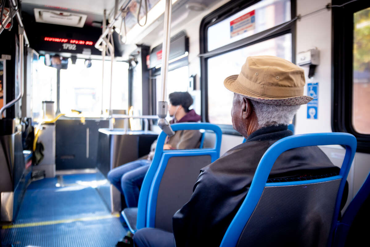 Elderly person and other young person on CTA bus.