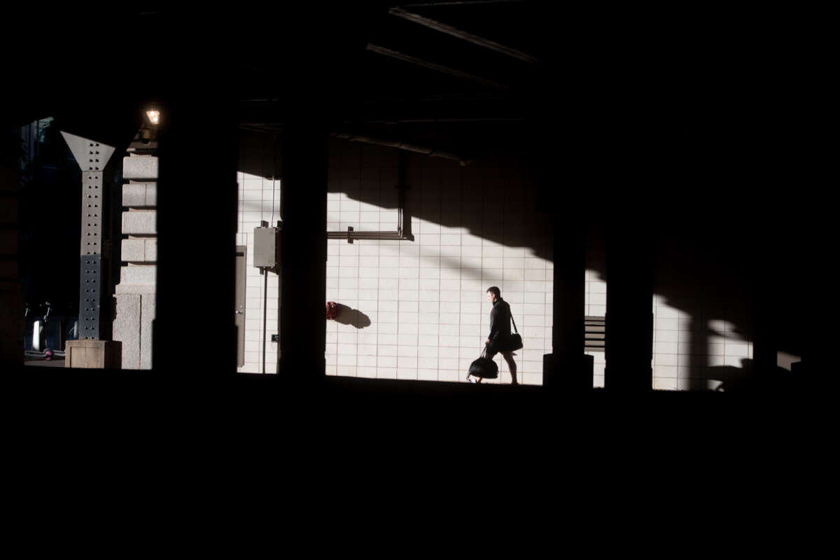 Dark silhouette of man walking through Ogilvie Union Station.