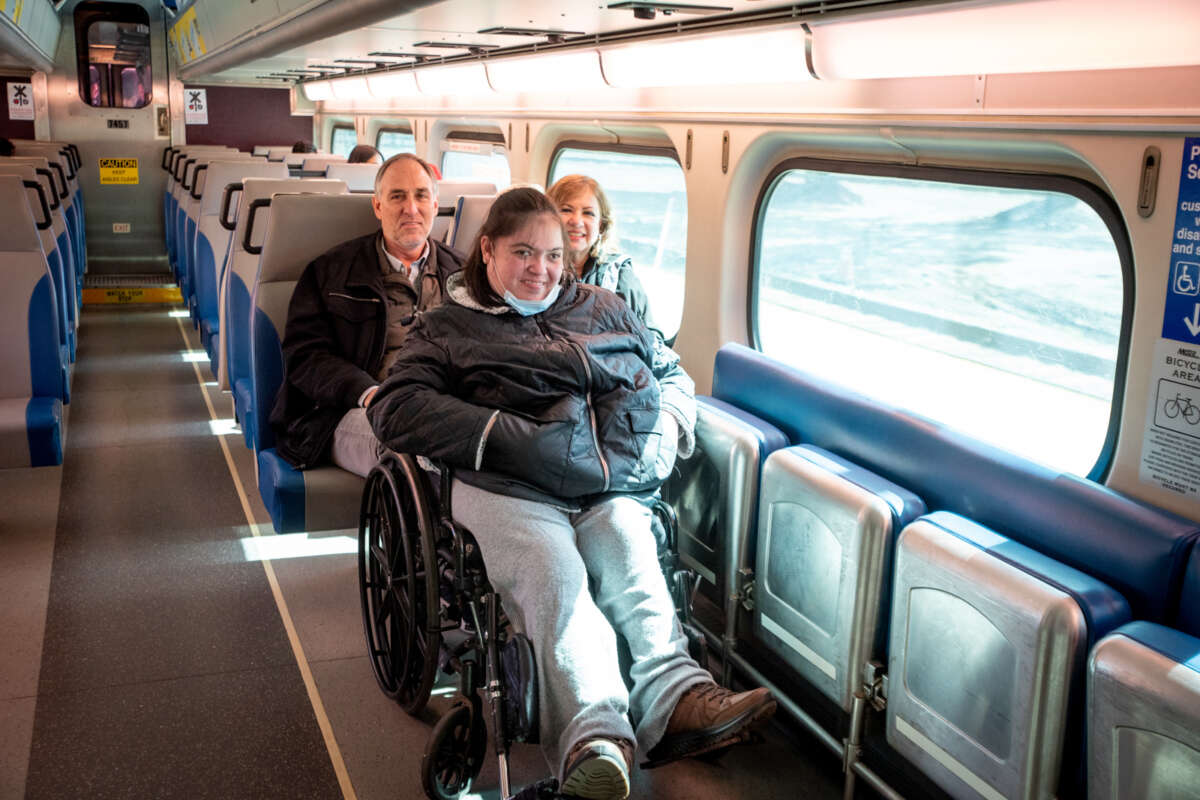 Person in wheelchair sitting in priority seating area on Metra train.