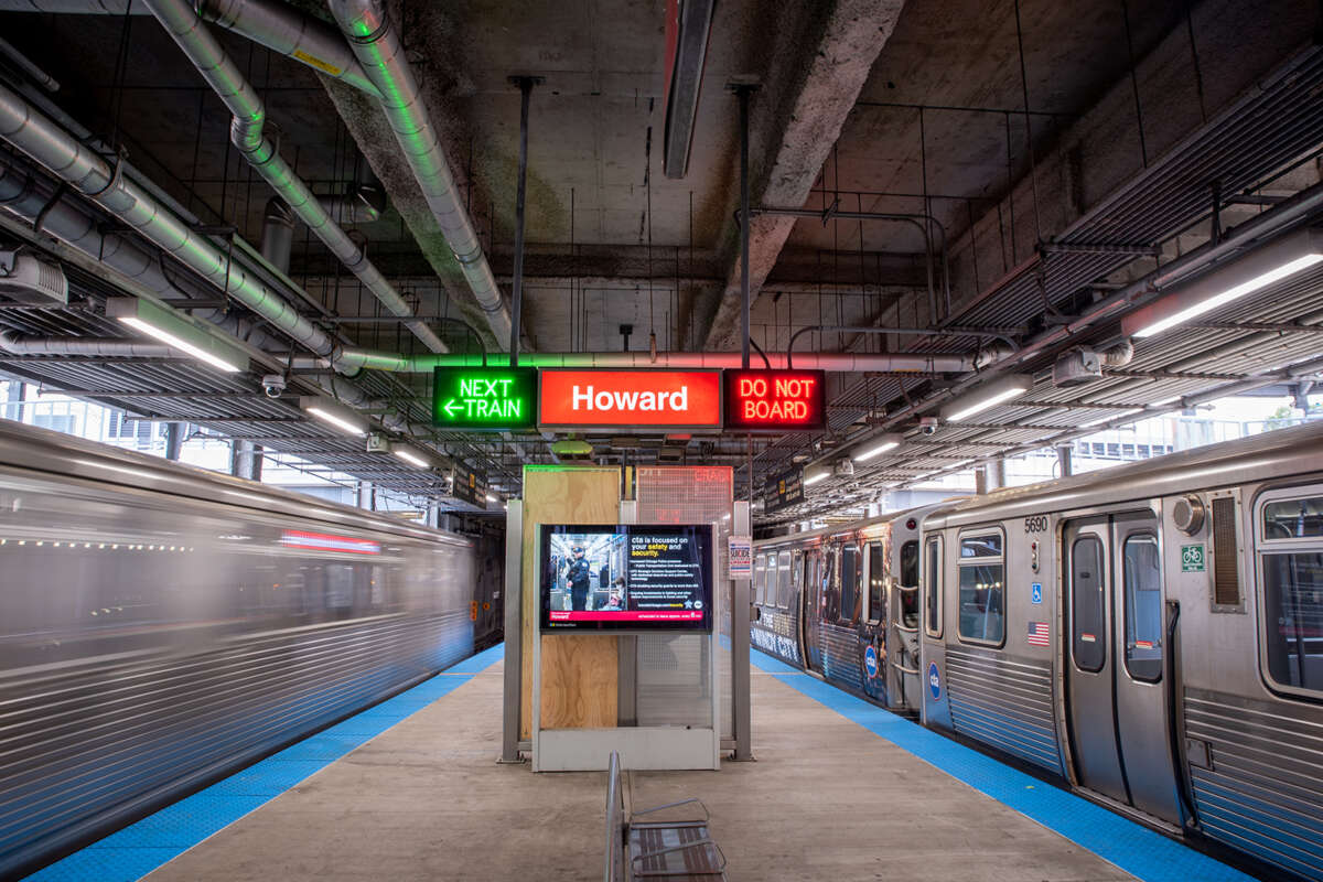 Center of 95th Howard Red Line platform, two L trains passing simultaneously.