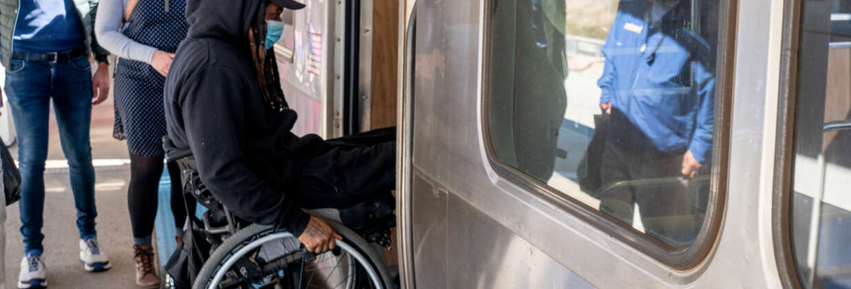 Person in wheelchair boarding CTA L train.